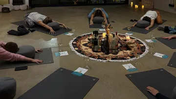 People doing yoga with center display.