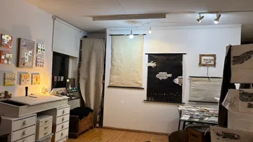 Art studio with paintings on walls.