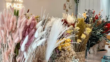 Dried flowers displayed in decorative baskets indoors.