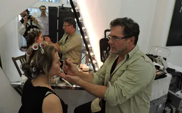 Makeup artist applying makeup in a salon.