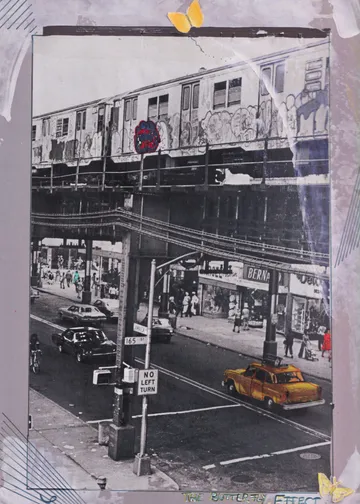 Elevated train with graffiti over busy city street.