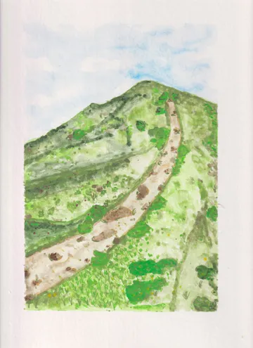 Mountain trail winding through green hills.