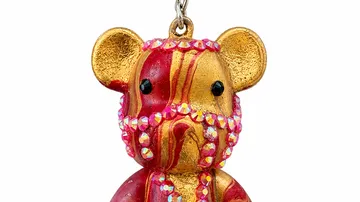Bear ornament with colorful gemstones, hanging.