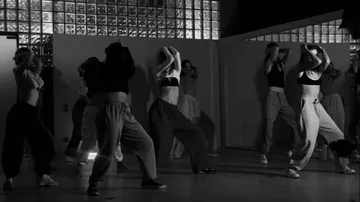 Dancers performing in a studio setting.