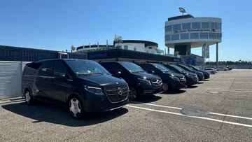 Mercedes vans parked in front of a building.
