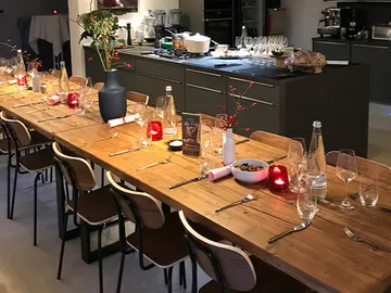 Long wooden table, set for a festive dinner in the kitchen