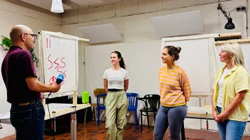 People presenting in a workshop room.