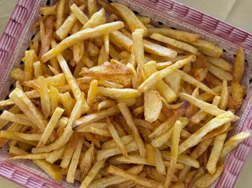 French fries in a basket on a table.