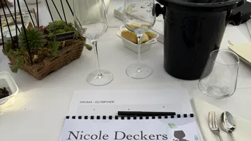 Wine glasses on table with notebook.