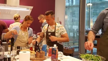 Menschen kochen zusammen in einer Küche.