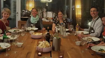 Group dining at wooden table in restaurant.