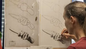 Artist draws hand holding an object.