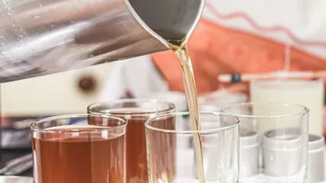 Liquid pouring into glass from pitcher.