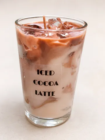 Glass of iced cocoa latte on table.