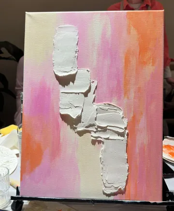 Textured white paint on colorful canvas.