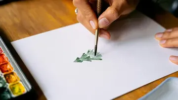 Hand malt Baum auf Papier, Aquarell-Setup.