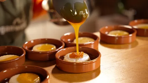 Caramel poured over dessert in small bowls.