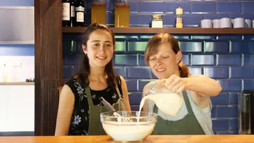 Two women baking in a kitchen.