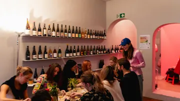 Menschen speisen in einer gemütlichen Weinbar.