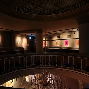 Art gallery displaying colorful abstract paintings.