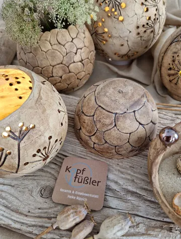 Ceramic spheres displayed on wooden surface.