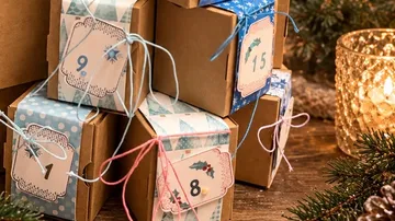 Advent calendar boxes stacked on a table.
