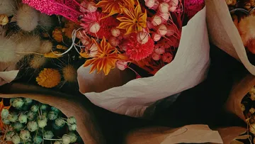 Colorful dried flowers in paper wrapping.