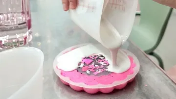 Pouring liquid into mold with sprinkles.
