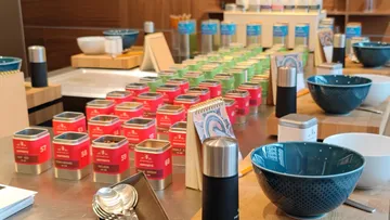 Colorful tins displayed on a shop counter.