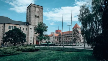 Historisches Gebäude neben grünem Rasen.