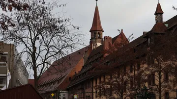 Historic building with spires in cityscape.