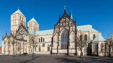 Historic cathedral with twin towers, blue sky.