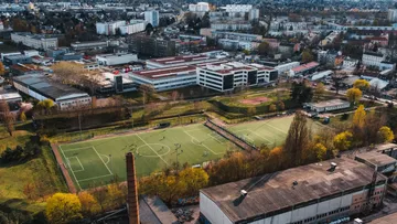 Aerial view soccer field in urban area.