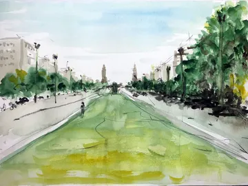 Green park with cyclists and buildings in the background.