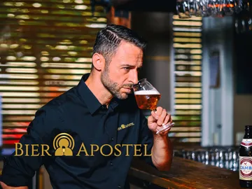 Man enjoying beer at a bar in a restaurant.