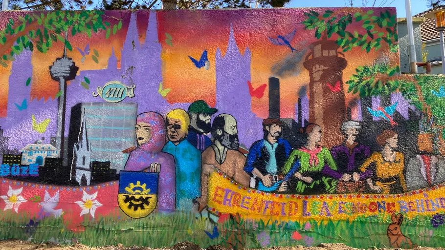 Colorful mural depicting people and cityscape.