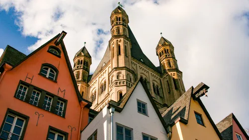 Colorful houses with church towers under blue sky.