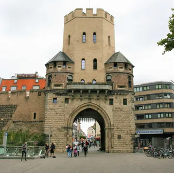 Medieval gate tower with people walking underneath.