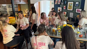 Group of women celebrating in a bar.