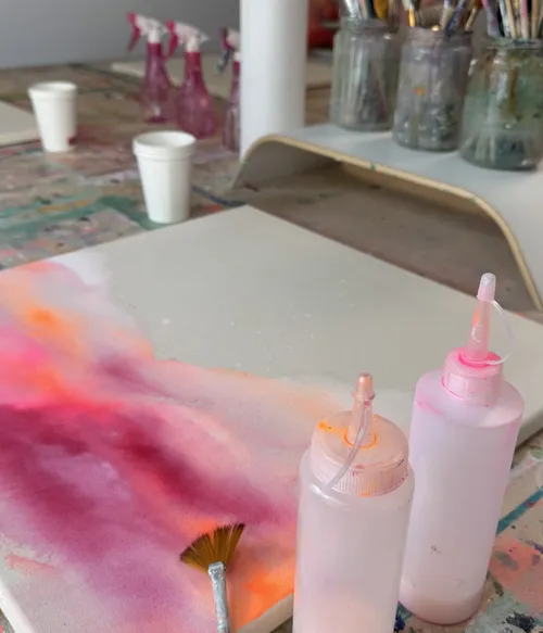 Art supplies on a colorful workstation.