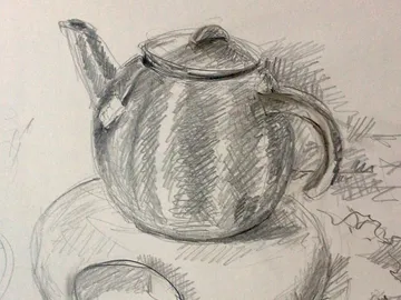 Teapot is placed on a table surrounded by shade.