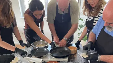 People cooking together in kitchen.