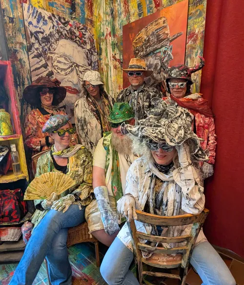 People wearing colorful, artistic costumes indoors.
