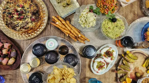 Table filled with various dishes and snacks.