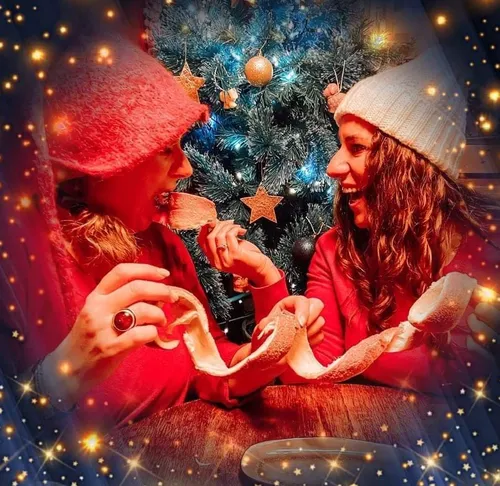 Two women peeling fruit near Christmas tree.