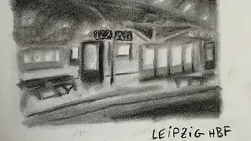 Train platform with station signs and benches.