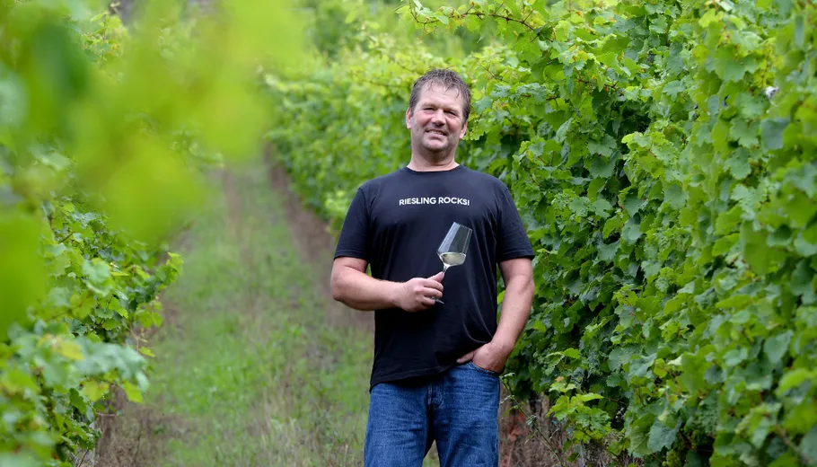 Man holding wine glass in vineyard