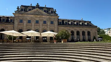 Historical building with outdoor seating area.