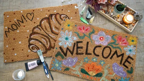 Two decorated mats and painting tools displayed.