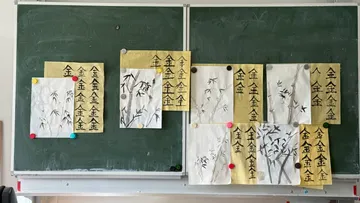 Pinselmalereien auf Tafel im Klassenzimmer.